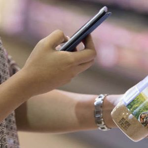 Woman scanning a barcode with a smart phone